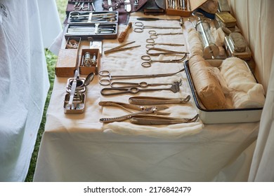 An Old Military Field Hospital With Retro Tents And Vintage Medical Beds From The First World War. Mobile Clinic For The Treatment Of Soldiers Of The Early Twentieth Century