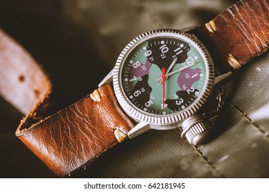 old military or field style of wristwatch with camouflage dial and leather band. - Powered by Shutterstock