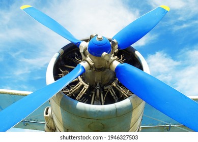 Old Military Plane Propeller Closeup. Vintage Fighter Plane Close Up By Blue Sky Background