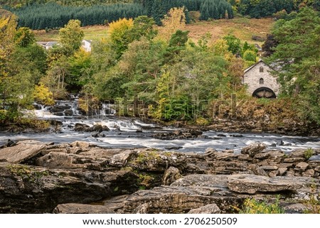 The Old Mill besides The Falls of Dochart, which are a series of rapids on the River Dochart in the village of Killin, Scotland, in the Trossachs National Park