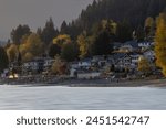 Old Mill Site Park in Port Moody BC as a historical significance (old sawmill) along the shoreline offering picturesque views of Burrard Inlet during sunset. 