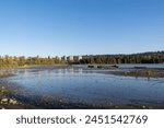 Old Mill Site Park in Port Moody BC as a historical significance (old sawmill) along the shoreline offering picturesque views of Burrard Inlet during sunset. 