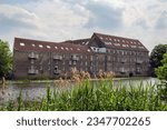 The old millhouse, now flats, on the river Great Ouse, Godmanchester, Huntingdon, Cambridgeshire, England.