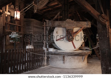Old millstones, vintage farming tools in action. Windmill of Zaanse Schans. Netherlands. Suburb of Amsterdam