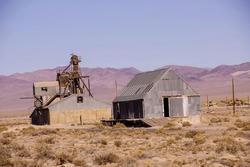 Old Mining Buildings, Rusting In The Desert,with Mountains In Background, Nevada