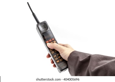 Old Mobile Phone in hand on white background.