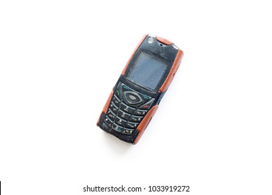An old mobile phone on a white background
