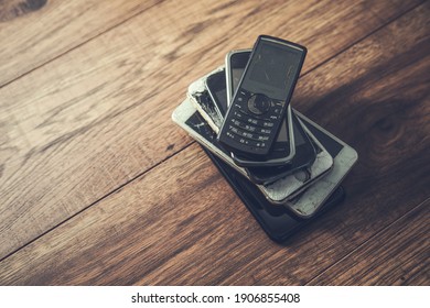 old mobile phones on a table background