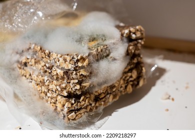 old moldy sliced bread lies in a bag - Shutterstock ID 2209218297