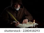 Old monk in the Middle Ages writes message