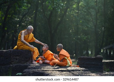 Old Monk are teach little monks of buddhist and spiritual ancient buddha on the laterite in the forest
