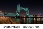 Old monumental railroad bridge called De Hef in Rotterdam beautiful lit during the night