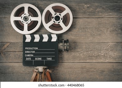 Old Movie Camera, Consisting Of A Tripod, Lens, Film Reels And Clapperboards