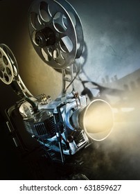 Old Movie Projector With The Film On The Dark Background