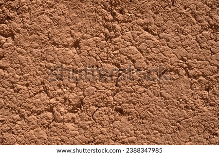 Old mud wall plaster with cracks close up

