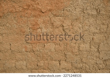 Old muddy adobe wall closeup
