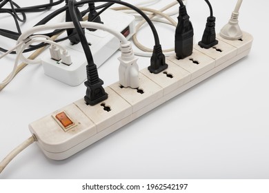 Old Multiple Power Socket With Connected Plugs , Multi Plug Electrical Power Strip On A White Background , Safety First Concept