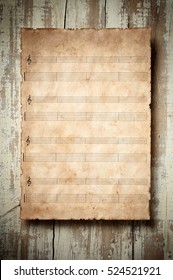 old music sheet with blank musical pentagram and tablature on aged wood