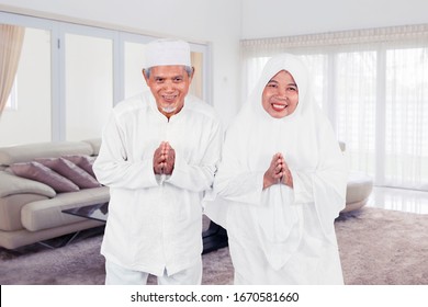 Old Muslim Couple Showing Greeting Gesture Together During Eid Mubarak Celebration At Home