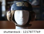 A old Navy soft helmet for aviation crewmen on a display mannequin.