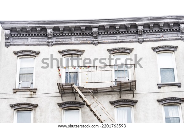 	\
Old New York apartment building with fancy\
terra cotta detailing Manhattan Lower East Side apartment building\
with external fire\
ladders