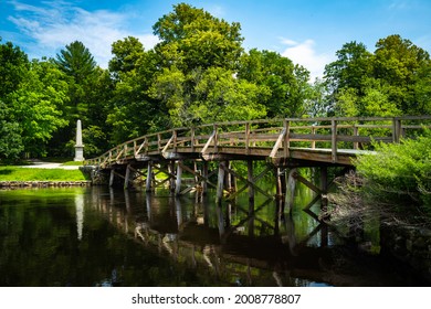 Old North Bridge At Minute Man National Historical Park In Concord, Massachusetts. Tranquil Nature Landscape With Landmark Bridge And Clean River. Peaceful American New England Image.