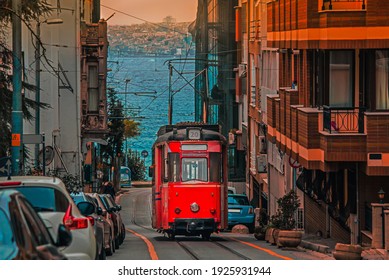 Old nostalgic tram going through the streets of Kadikoy district on the Asian side of Istanbul. The trendy neighborhood is full of colorful buildings. Marmara Sea.