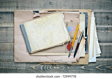Old Notebook, Envelope With Paper And Pens On A Wooden Table