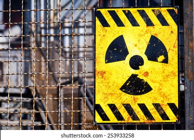 old nuclear warning sign at a fence