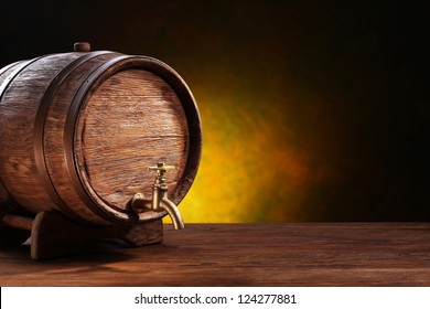 Old Oak Barrel On A Wooden Table. Behind Blurred Dark Background.