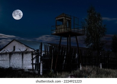 Old observation tower in old Soviet Russian prison complex at moonlight night
