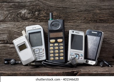 Old and obsolete mobile phone on old wood shelf 