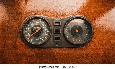 Old Odometer And Speedometer In Kilometers Per Hour On Old Wooden Dashboard