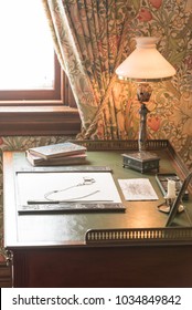 Old Office Table With Books And A Lamp