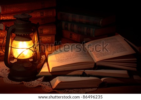 Old oil lamp and old books