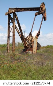 Old Oil Pump Jack In Field 