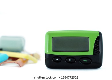 An Old One Way Pager Against White Background And Accessories. Pager Can Be Changed Many Color Of Case.