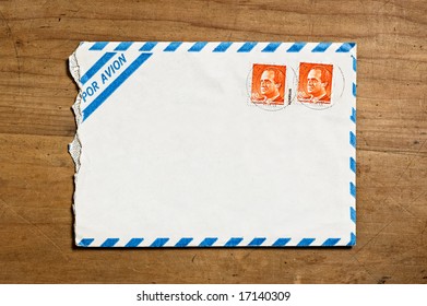 Old Open Air Mail Envelope Over A Wooden Table.