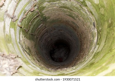 old open concrete sewer well outdoors close-up view from above - Shutterstock ID 1930071521