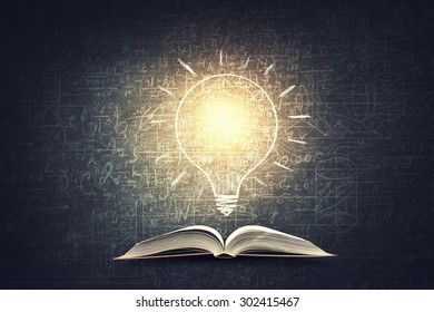 Old opened book with business sketches over black background - Shutterstock ID 302415467