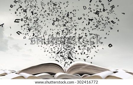 Old opened book with characters flying out of pages