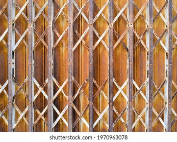 Old Orange Rust Rolling Steel Door In Home Pattern.