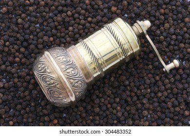 Old oriental brass pepper mill and black pepper. - Powered by Shutterstock