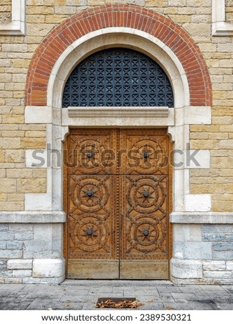 Old ornate entrance door in the Roman-Byzantine style, part of the Visitation convent created in 1850 on Fourviere hill, Lyon, France