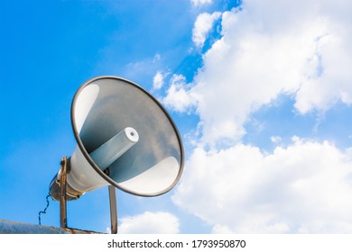 The old outdoor speaker of a megaphone with a bright blue sky background