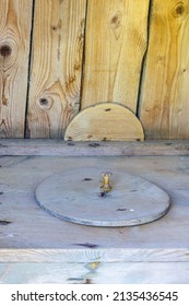 Old Outhouse With A Wooden Lid