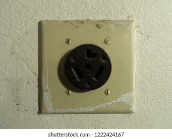 An Old Outlet For A Dryer In A Garage.