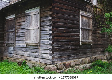 Old overgrown wooden house with a stone foundation built in traditional style in Lithuania - Powered by Shutterstock