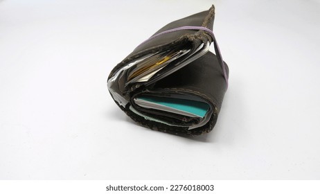 Old Overstuffed Man's Wallet Held Together with Elastic Band. - Shutterstock ID 2276018003