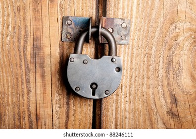 Old Padlock On A Wooden Door